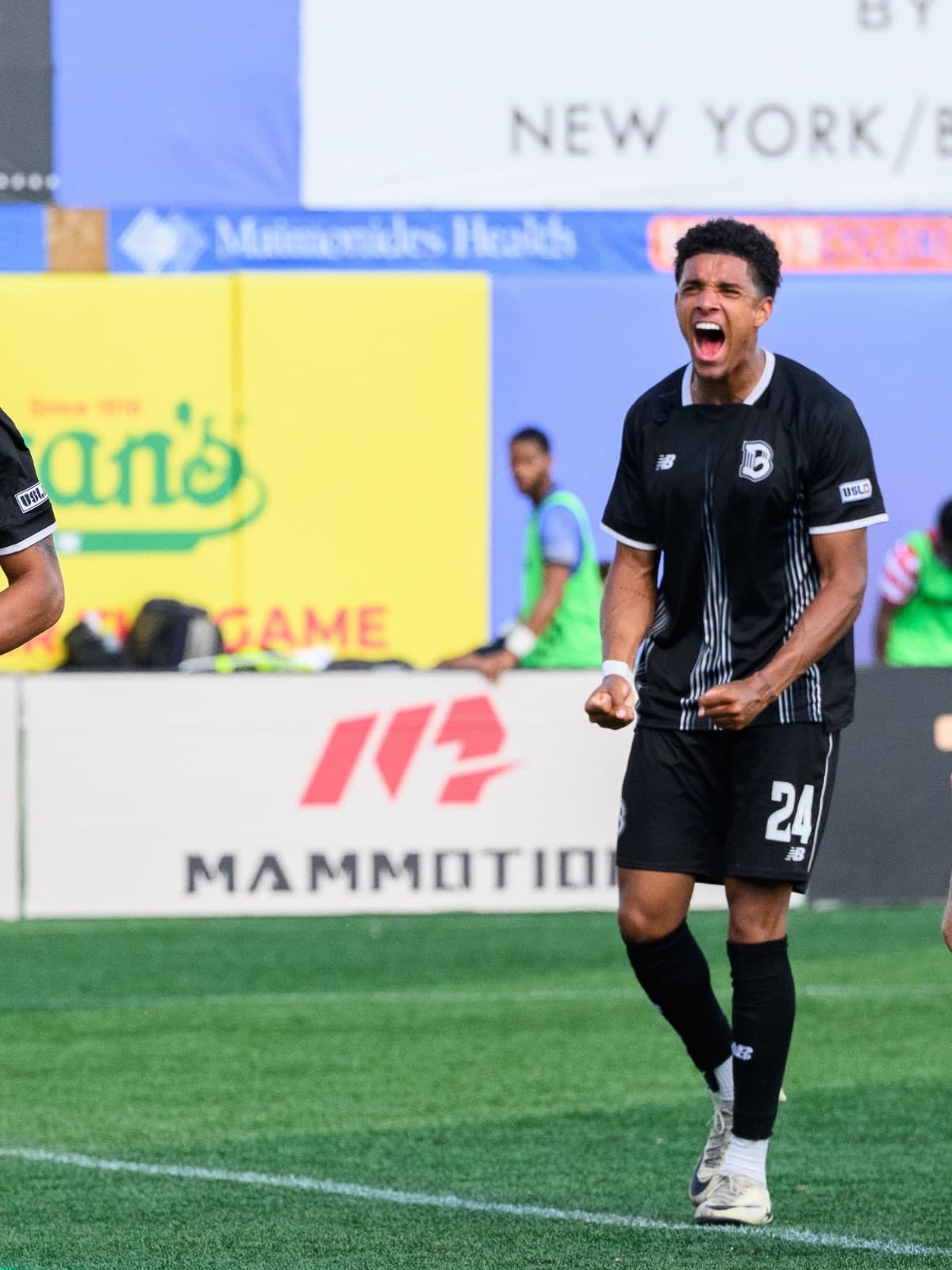 Callum Frogson roaring in celebration in the Brooklyn FC home kit